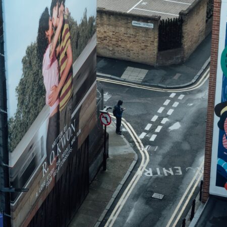 city street with billboard and pedestrian in london