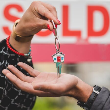 person handing out a house key