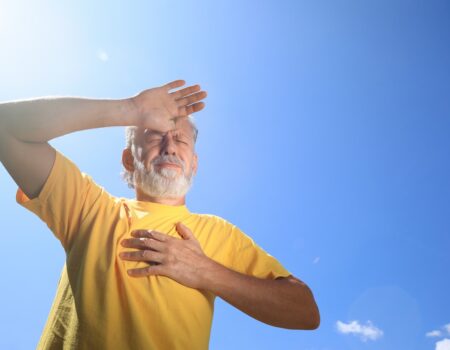 Senior man suffering from heat stroke outdoors