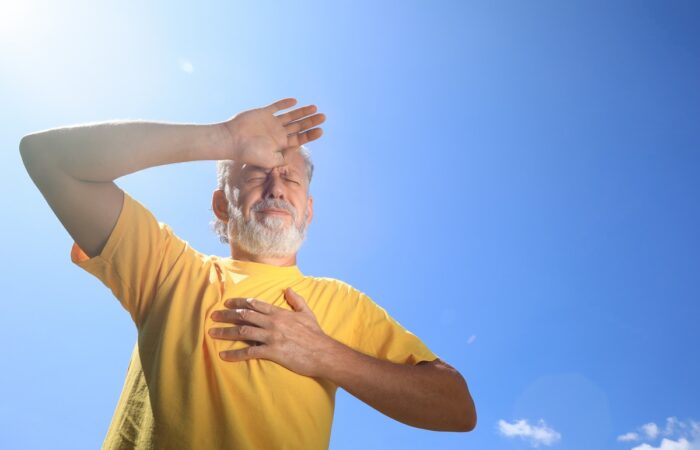 Senior man suffering from heat stroke outdoors